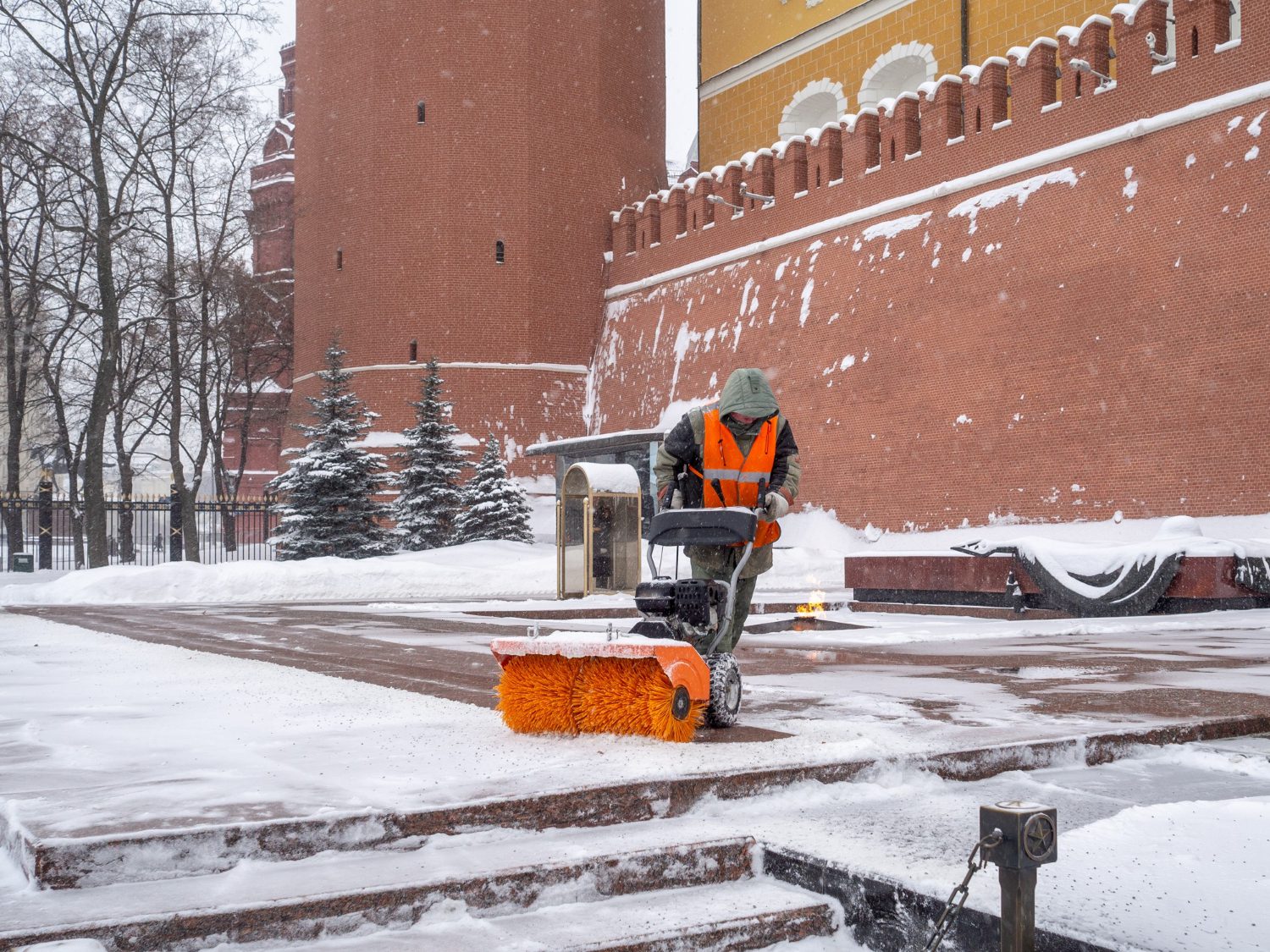 utility-worker-cleans-snow-with-snowplow-grave-unknown-soldier-kremlin-during-snowfall utility-worker-cleans-snow-with-snowplow-grave-unknown-soldier-kremlin-during-snowfall